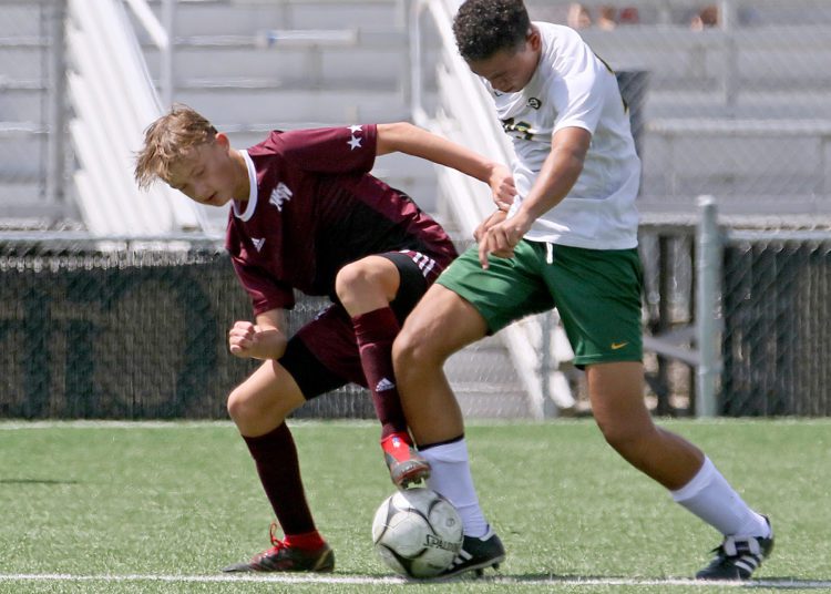 (Brad Davis/For LootPress) Woodrow Wilson's Tyler Synder battles for possession with Brooke's Kendrick Fish Saturday afternoon at the YMCA Paul Cline Memorial Sports Complex.