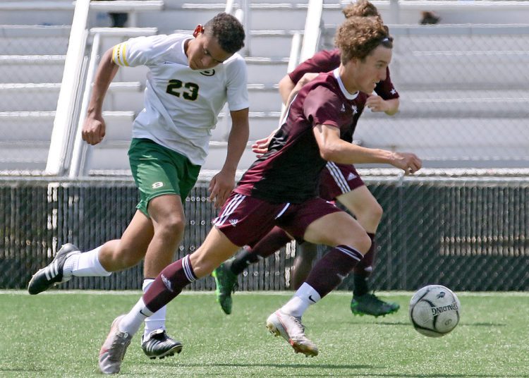 (Brad Davis/For LootPress) Woodrow Wilson's Carson Eckley charges past Brooke's Kendrick Fish before scoring on the play Aug. 28 at the YMCA Paul Cline Memorial Sports Complex.