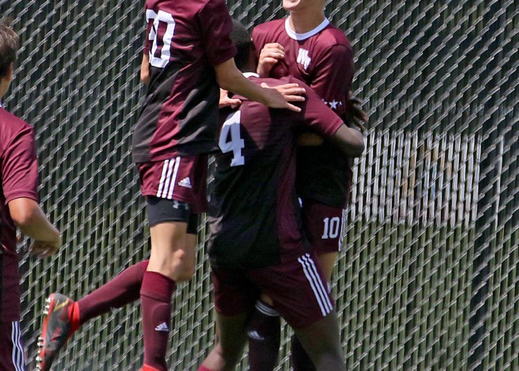 (Brad Davis/For LootPress) Woodrow Wilson's Carson Eckley, right, is mobbed by teammates after scoring a goal against Brooke Saturday afternoon at the YMCA Paul Cline Memorial Sports Complex.