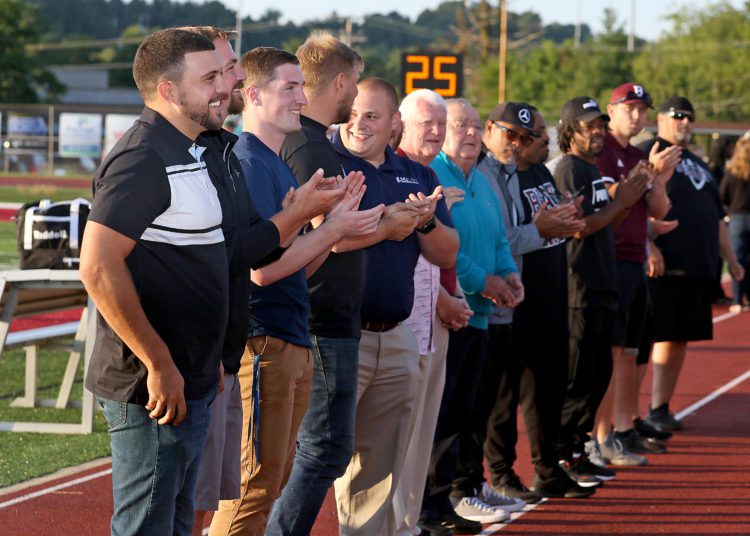 (Brad Davis/For LootPress) Newly inducted and current members of the Woodrow Wilson Hall of Fame share a few laughs together as they're honored during a pregame ceremony Friday night in Beckley.