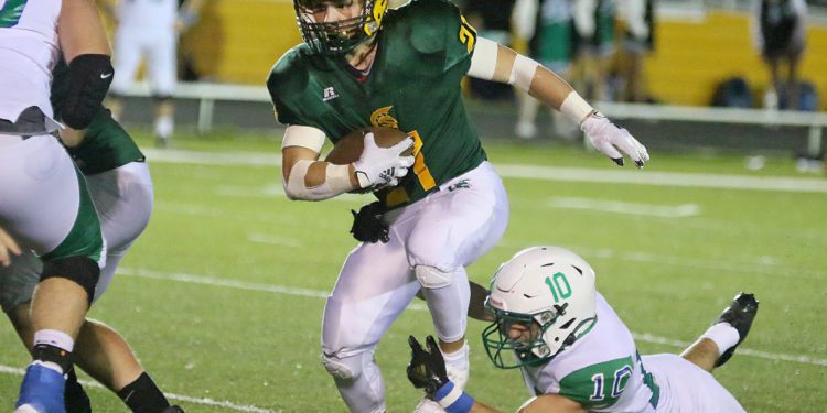 (Brad Davis/For LootPress) File Photo - Greenbrier East's Ian Cline breaks a tackle attempt from Robert C. Byrd's Evan Warne as he carries the ball Sept. 10 in Fairlea