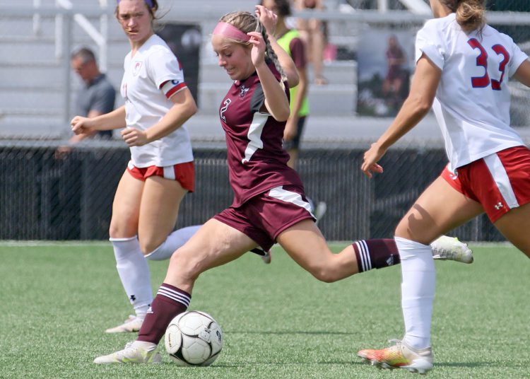 (Brad Davis/For LootPress) Woodrow Wilson's Abby Dillon fires a shot towards the goal after getting past Wheeling Park defender Mia Zecca (#33) Saturday afternoon at the YMCA Paul Cline Memorial Sports Complex.