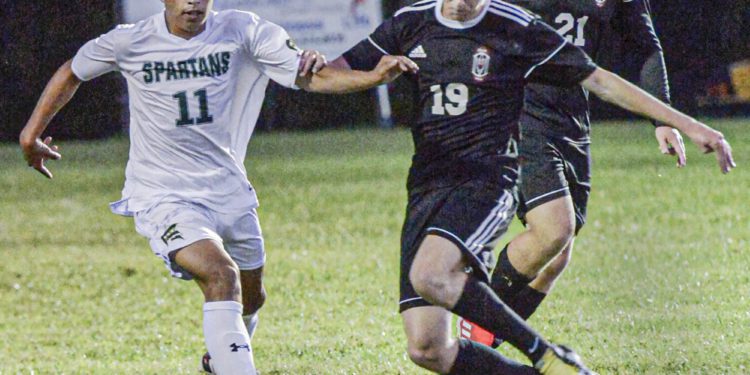 Greenbrier East’s #11 Roberto Martinez and Oak Hill’s #19 Colton Workman fight for the ball during Thursday evening action in Oak Hill. (F. Brian Ferguson/Lootpress).