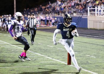 Nicholas County’s (4) runs into the end zone for a touchdown in the first quarter as James Monroe’s (13) looks on during their football game in Summersville on Friday, Oct. 29, 2021 (Photo by Chris Jackson)