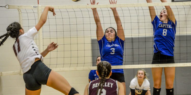 KENNY KEMP | Gazette-Mail
Capital's Tori Barone (3) and Kayla Moffatt (8) try to block the return ball of Woodrow Wilson's Elysia Salon (17).