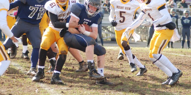 Mount View's (61), Tony Bailey (5) and Justin Haggerty (1) attempt to bring down Ritchie County's Gus Morrison. (Jay Bennett/The Parkersburg News and Sentinel)