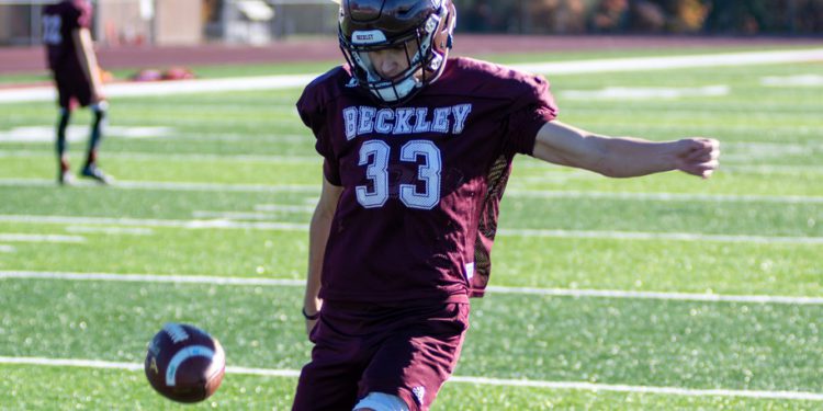 Beckley's Connor Mollohan punts the ball during a practice at Woodrow Wilson High School on Monday. (Heather Belcher/Lootpress)