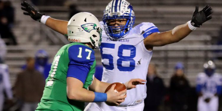 Robert C. Byrd quarterback Nicholas George tries to avoid a sack as Fairmont Senior’s Eric Smith closes in (Photo by John Bryan, The Exponent Telegram)