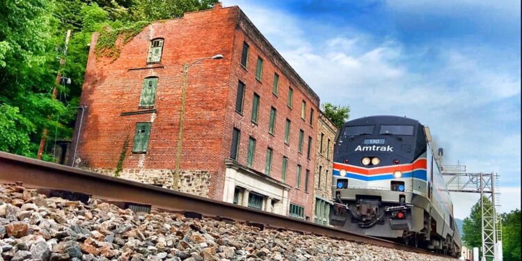 The Amtrak 51 Cardinal rolls by historic Commercial Row in Thurmond.