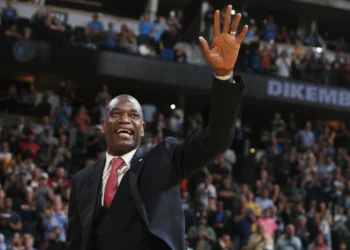 Retired Denver Nuggets center Dikembe Mutombo waves to the crowd as his jersey number was retired by the team during halftime of the Nuggets' NBA basketball game against the Portland Trail Blazers on Saturday, Oct. 29, 2016, in Denver. (AP
Photo/David Zalubowski, File)