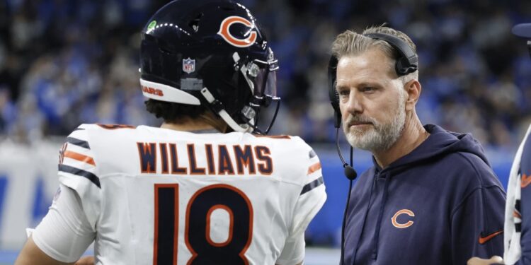 Chicago Bears quarterback Caleb Williams (18) talks with head coach Matt Eberflus during the second half of an NFL football game in Detroit, Thursday, Nov. 28, 2024. (AP Photo/Duane Burleson)