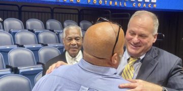 West Virginia coach Rich Rodriguez hugs a fan following his introductory NCAA college football news conference Friday, Dec. 13, 2024, in Morgantown, W.Va. (AP Photo/John Raby)