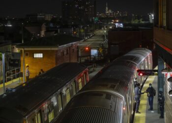 FILE - New York Police officers clear a train at the Coney Island Stillwell Avenue Terminal, May 5, 2020, in the Brooklyn borough of New York. (AP Photo/Frank Franklin II, file)