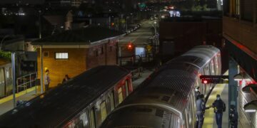 FILE - New York Police officers clear a train at the Coney Island Stillwell Avenue Terminal, May 5, 2020, in the Brooklyn borough of New York. (AP Photo/Frank Franklin II, file)