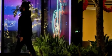 A neon TikTok logo hangs in the lobby of the TikTok office building in Culver City, Calif., on Tuesday, Dec. 3, 2024. (AP Photo/Richard Vogel)